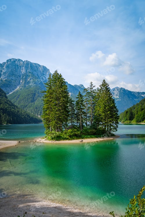 Preview: A Vertical Shot Of Trees On A Small Island On A Lake Surrounded By Scenic Hills And Mountains