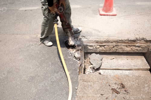 Preview: Worker Working On The Road Site Demolishing Asphalt With Pneumatic Plugger Hammer