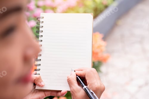 Preview: Woman Taking Notes In A White Flower Garden