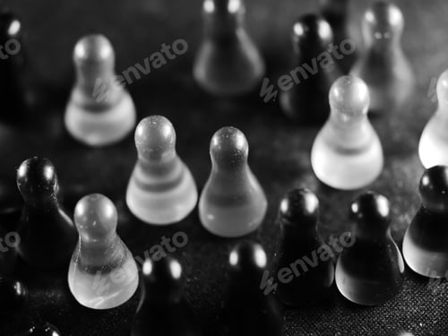 Preview: A Grayscale Wallpaper Of Glass Chess Pieces Stacked On The Floor Under Bright Light