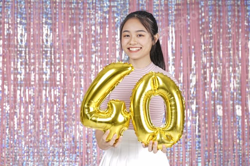 Preview: Asian Young Teenager Pretty Cheerful Beautiful Girl With Party Gold Foil Balloon, On Pink Sparkling