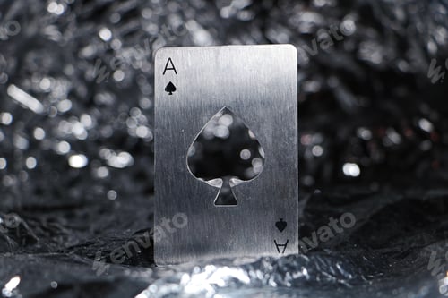 Preview: A Closeup Shot Of An Ace Of Spades Metallic Card Isolated On The Silver, Bokeh Background