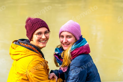 Preview: The Portrait Of A Cute Lesbian Couple Smiling At The Camera With River Backgroud, Austria