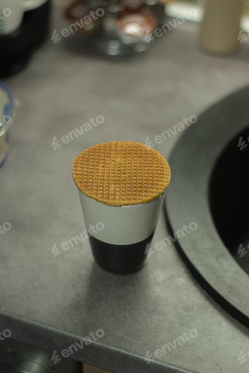 Preview: A Vertical Selective Focus Shot Of A Waffle On A Black And White Cup