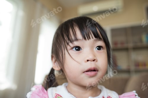 Preview: Portrait Of Little Asian Girl Playing In Her Home