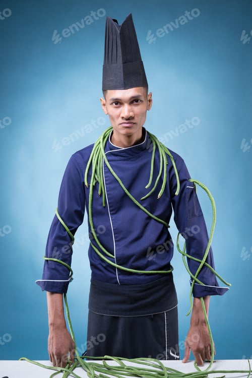 Preview: A Portrait Of An Asian Executive Chef In His Blue Uniform, Black Apron And Black Hat On Blue