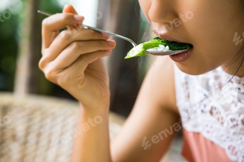 Preview: A Young Girl Is Eating Vegetable.