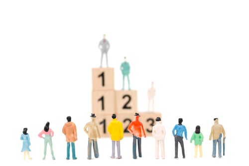 Preview: Group Of Miniature Businessman On White Background