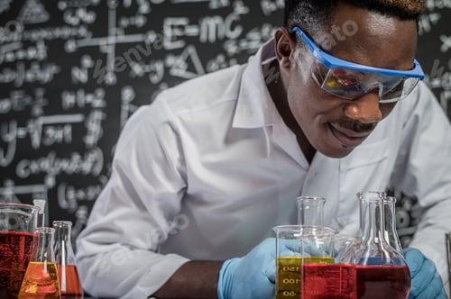 Preview: Scientists Look At The Chemicals In Glass At The Laboratory.
