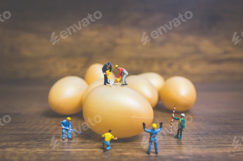 Preview: Miniature People Work At Easter-Eggs For Easter Day On Wooden Background