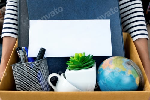 Preview: Employee Holding Resignation Letter And Packing A Box To Leave The Office