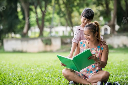 Preview: Mother And Daughter Reading A Fairytale To Her Daughter In The Park