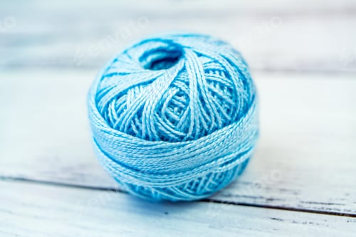 Preview: Ball of Blue Yarn on White Wooden Surface