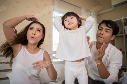Preview: Happy Child With Parents Playing In The Bed At Home
