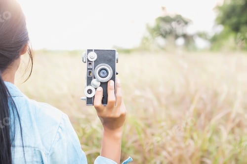 Preview: Woman Photographed In A Meadow With A Camera.
