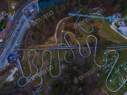 Preview: An Aerial View Of Curvy Bobsleigh Tracks In A Beautiful Forest