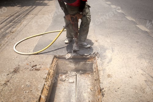 Preview: Worker Working On The Road Site Demolishing Asphalt With Pneumatic Plugger Hammer
