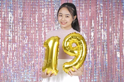 Preview: Asian Young Teenager Pretty Cheerful Beautiful Girl With Party Gold Foil Balloon, On Pink Sparkling