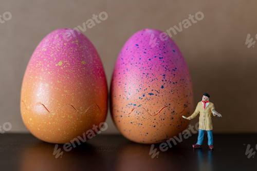 Preview: Miniature People : Artist Is Holding A Brush And Paint Easter-Eggs For Easter Day