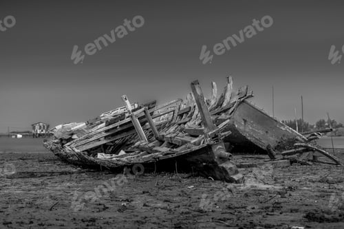Preview: A Greyscale Shot Of The Ruins Of A Wooden Boat On The Beach Captured In Bontang, Indonesia