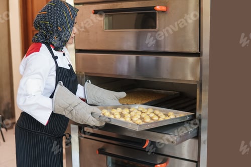 Preview: Female Pastry Chef Put A Dough Into The Oven