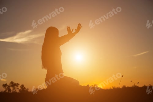 Preview: Silhouette Of Woman Praying Over Beautiful Sky Background