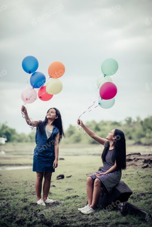 Preview: Happy Group Girl Friends Hand Holding Multicolored Balloons