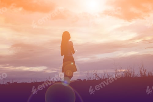 Preview: Silhouette Of Woman Praying Over Beautiful Sky Background