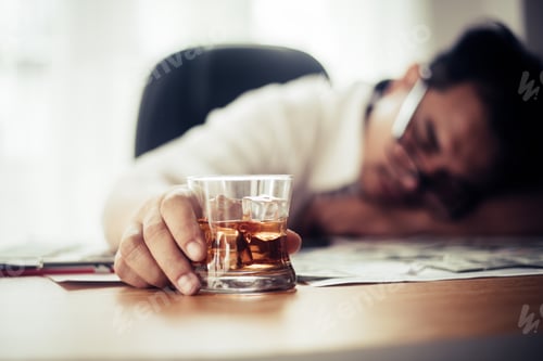 Preview: Businessman Drinking From Stress At Workplace