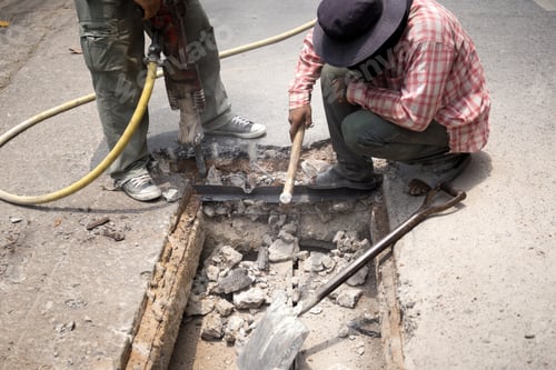 Preview: Worker Working On The Road Site Demolishing Asphalt With Pneumatic Plugger Hammer