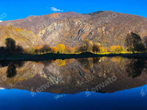 Preview: A Landscape Of The Lake With The Reflection Of Hills And Trees On It Under The Sunlight At Daytime