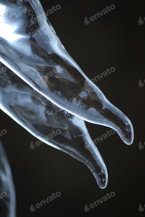 Preview: A Vertical Shot Of Icicles Isolated On A Dark Background