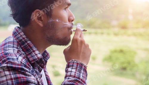 Preview: Hipster Man Smoking Cigarette, Standing Behind A Mountain. Among The Fresh Air In The Morning.