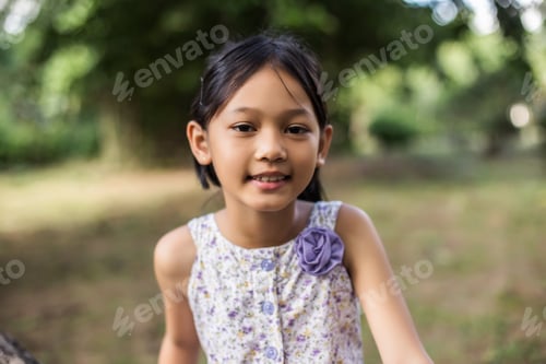 Preview: Little Cute Asian Girl Standing Among The Purple Flower Field Sunshine Day. Freedom Enjoying With