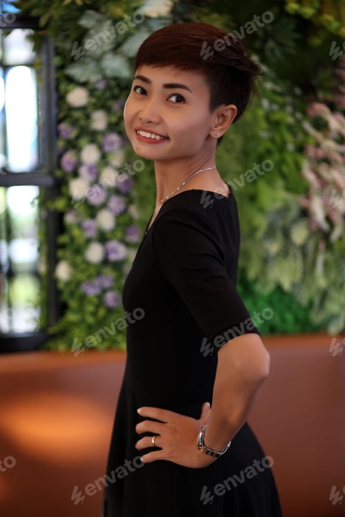 Preview: A Woman Standing Smiling Happily Making Eye Contact.