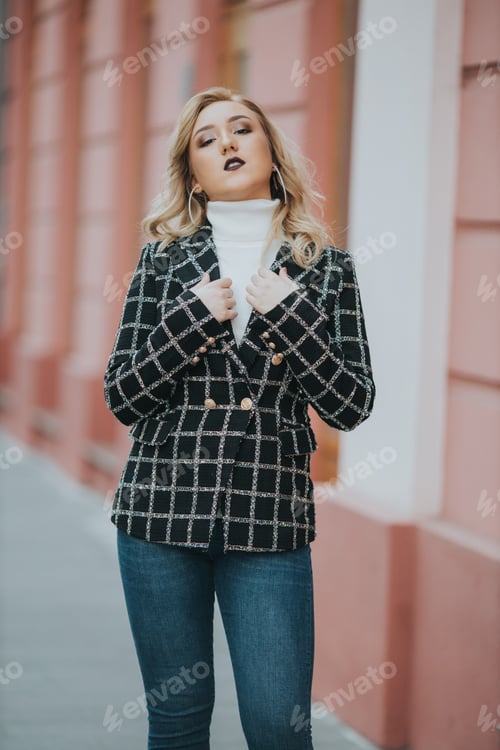 Preview: A Vertical Shot Of A Blonde Female Posing In An Elegant Black And White Checkered Jacket