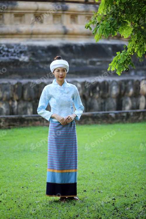 Preview: Portrait Of Thai Young Woman With Traditional Thai Dress In Thai Temple With Tree And Sunrise