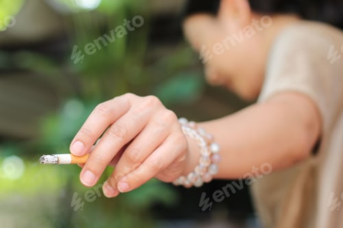 Preview: Woman Holds Cigarette In Her Hand Health Care Concept.