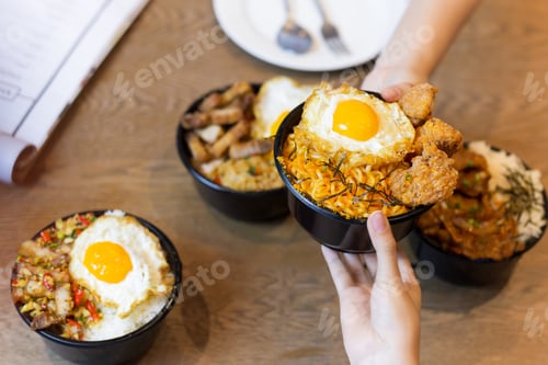 Preview: Shooting In Low Light Couple Holding Tasty Noodle With Fried Egg On Top.
