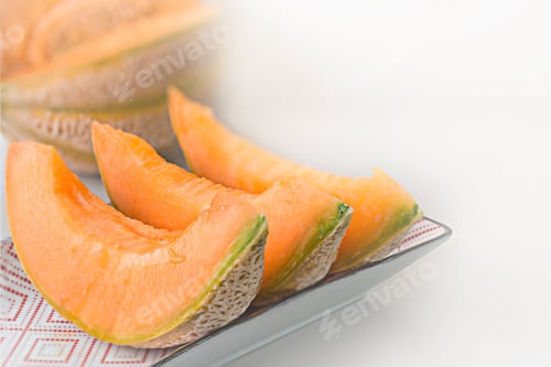 Preview: A Closeup Shot Of Sweet And Tasty Sliced Melons On A Plate Isolated On A White Background