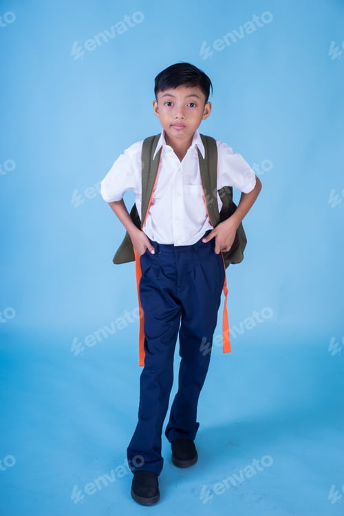 Preview: An Asian Muslim School Boy Wearing White Shirt, Blue Pants School Uniform And Backpack Over Blue