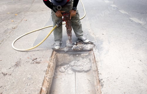 Preview: Worker Working On The Road Site Demolishing Asphalt With Pneumatic Plugger Hammer