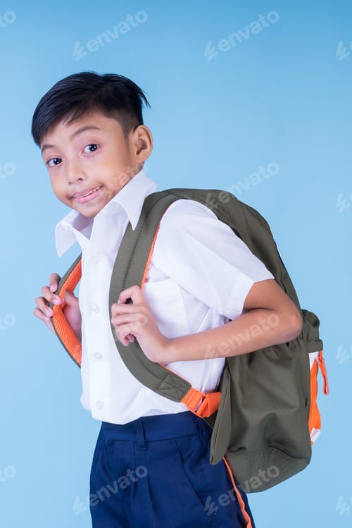 Preview: An Asian Muslim School Boy Wearing White Shirt, Blue Pants School Uniform And Backpack Over Blue