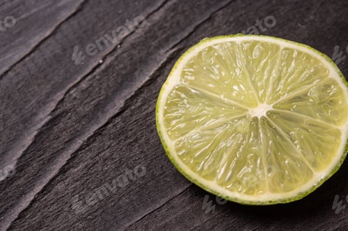 Preview: A Closeup Shot Of Cut Limes On Dark Background