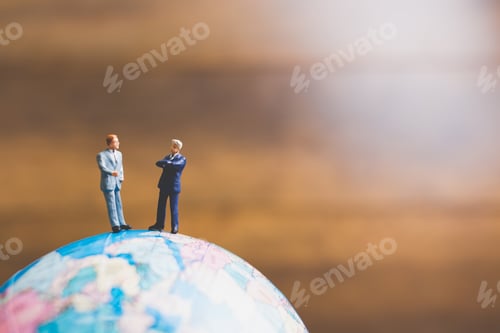 Preview: Miniature People , Businessman Standing On The Globe World Map With Brown Background And Copy Space