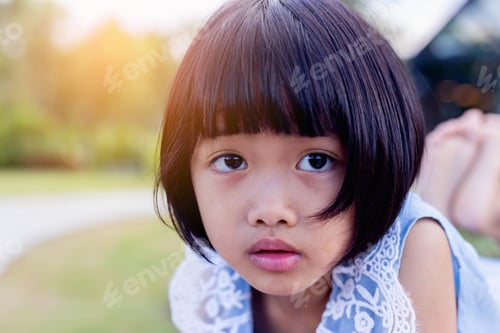 Preview: Happy Cute Child Girl On The Blur Green Background.