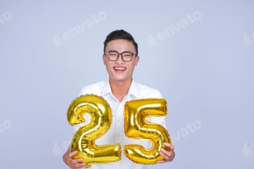 Preview: Asian Young Handsome Attractive Male Student Holding Metallic Foil Balloon With Number