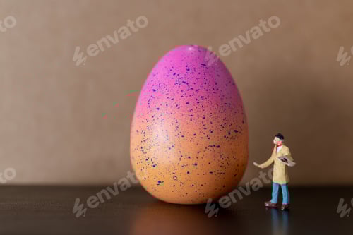 Preview: Miniature People : Artist Is Holding A Brush And Paint Easter-Eggs For Easter Day