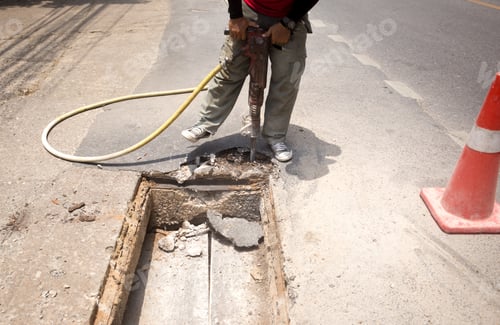 Preview: Worker Working On The Road Site Demolishing Asphalt With Pneumatic Plugger Hammer