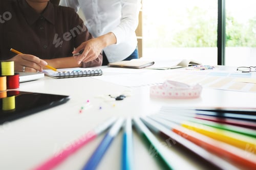Preview: Group Of Young Creative Fashion Designers Working Hard On Project At A Studio